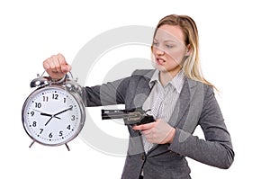 Businesswoman in gray suit holding alarm clock