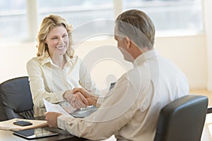 Businesswoman Greeting Colleague In Office
