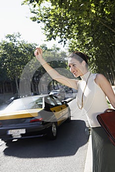 Businesswoman Hailing A Cab