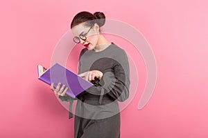 Businesswoman with hair bun and book