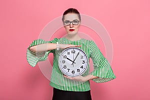 Businesswoman with hair bun and clocks