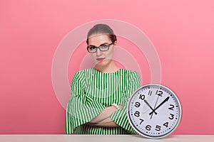 Businesswoman with hair bun and clocks