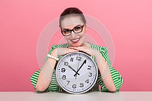 Businesswoman with hair bun and clocks