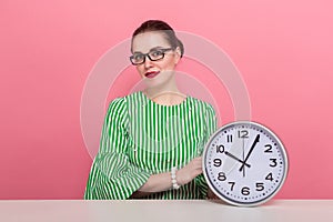 Businesswoman with hair bun and clocks