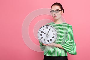 Businesswoman with hair bun and clocks