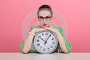 Businesswoman with hair bun and clocks