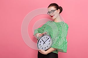 Businesswoman with hair bun and clocks