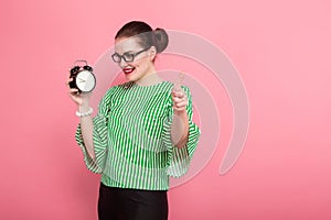 Businesswoman with hair bun and clocks