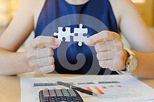 Businesswoman Hand connecting couple puzzle piece