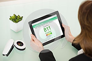 Businesswoman Hand With Digital Tablet Showing Credit Score