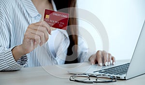 Businesswoman hand holding credit card to online shopping from home, payment e-commerce, internet banking, spending money for next