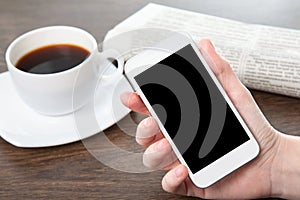 Businesswoman hand holding a phone in the office