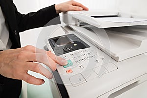 Businesswoman Hand Pressing Printer's Button