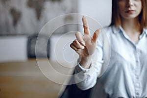 Businesswoman hand pushing screen at the office