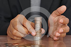 Businesswoman hand putting money coin stack. Creative ideas for saving money concept