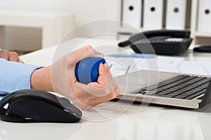 Businesswoman hand squeezing stress ball