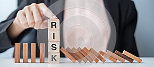 Businesswoman hand Stopping Falling wooden Blocks or Dominoes. Business, Risk Management, Solution, Insurance and strategy