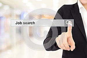 Businesswoman hand touching job search on search bar over blur b