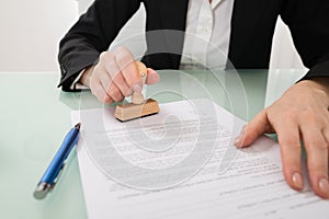 Businesswoman Hand Using Stamper On Document
