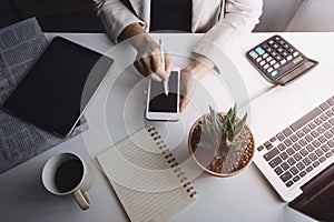 businesswoman hand working with laptop computer, tablet and smart phone in modern office with virtual icon diagram at modernoffice