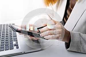 businesswoman hand working with laptop computer, tablet and smart phone in modern office with virtual icon diagram at modernoffice