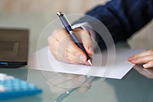 Businesswoman hand write on blank paper