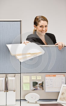 Businesswoman handing co-worker file folder