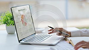 Businesswoman hands are analyzing charts, graphs, financial data. and accounting documents The displayed data calculate