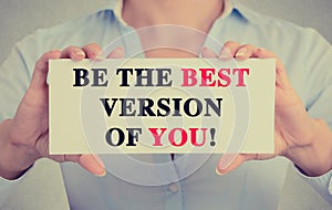 Businesswoman hands card sign with be the best version of you message