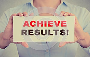 Businesswoman hands holding card sign with achieve results message