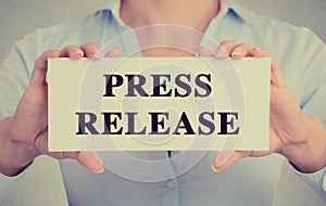 Businesswoman hands holding card sign with press release message