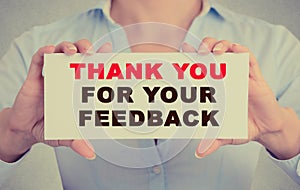 Businesswoman hands holding card with Thank you for your feedback message