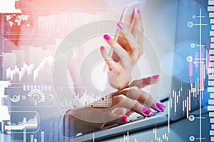 Businesswoman hands with pink nails working on laptop and smartphone. Stock market changes, business candlesticks graph chart.