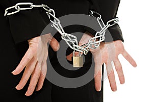 Businesswoman with hands shackled in chains.