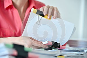 Businesswoman hands sorting business reports and stock charts