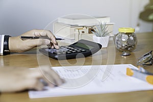 Businesswoman hands using calculator and cost at the office