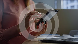 Businesswoman hands using touchpad on smartphone screen. Woman texting message