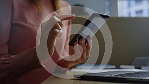 Businesswoman hands using touchpad on smartphone screen. Woman texting message