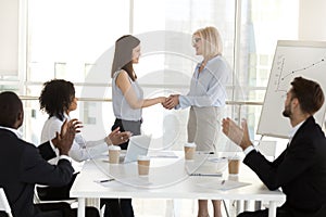 Businesswoman handshake female employee congratulating with succ