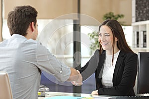 Businesswoman handshaking with client closing deal