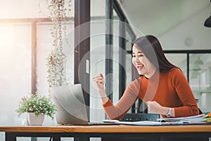 Businesswoman happy and cheerful for successful on project via laptop