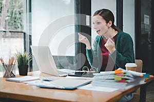 Businesswoman happy and cheerful for successful on project via laptop