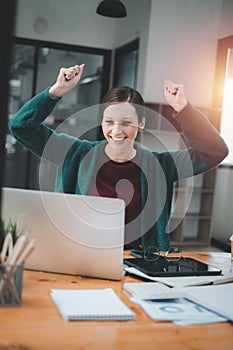 Businesswoman happy and cheerful for successful on project via laptop