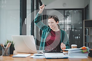 Businesswoman happy and cheerful for successful on project via laptop