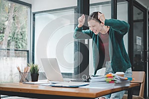 Businesswoman happy and cheerful for successful on project via laptop