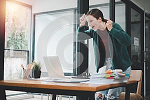 Businesswoman happy and cheerful for successful on project via laptop