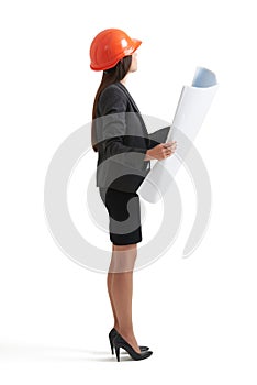 Businesswoman in hardhat holding blueprint