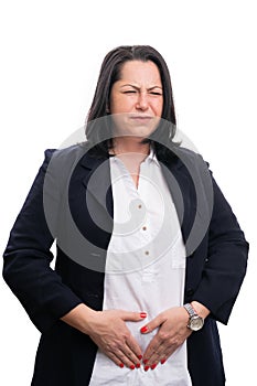 Businesswoman having abdominal pains touching stomach