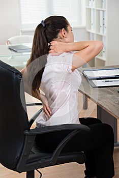 Businesswoman Having Backpain In Office