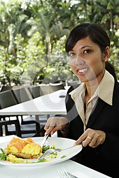 Businesswoman having breakfast